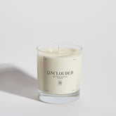 Boujie Unclouded luxury soy wax jar candle, front view, handmade with natural soy wax in a clear glass jar, scented with rock salt and driftwood, styled with coastal-inspired elements.